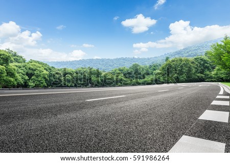 Asphalt highways and mountains under the blue sky