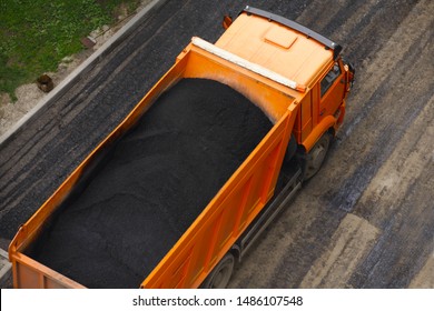 The Asphalt Is Hot In The Truck. Road Works Flooring Asphalt Laying. Top View