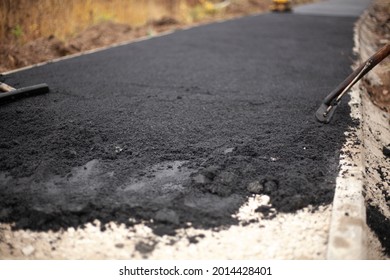 Asphalt Laying. Repair Of The Footpath. Smoothing Hot Pavement.