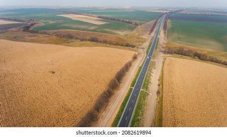 Asphalt New Road Along The Fields,  Road Seen From The Air. Aerial View Landscape. Dron  Photography.