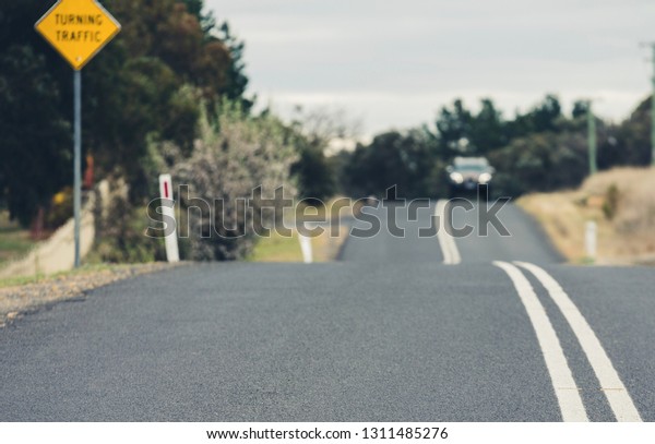Asphalt open\
country road and car in\
Australia
