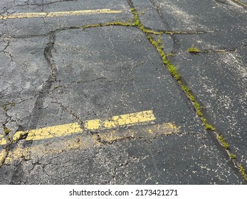 Asphalt Parking Lot In Need Of Repair.