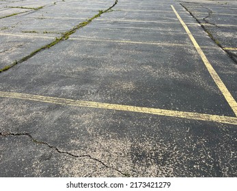 Asphalt Parking Lot In Need Of Repair.