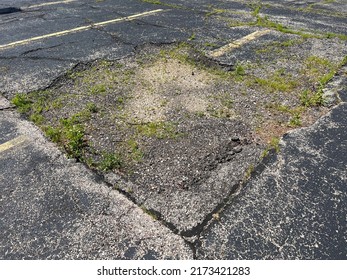 Asphalt Parking Lot In Need Of Repair.