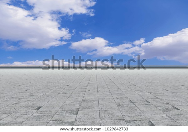 Asphalt pavements and square floor tiles under the blue\
sky and 