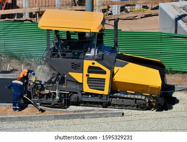 Asphalt Paver Laying Asphalt Layer During Road Repair.