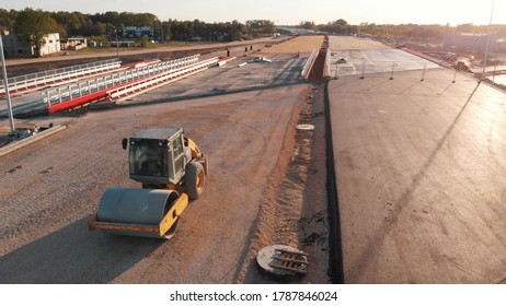 Asphalt Paver Machine And Steam Road Roller During New Road Construction Aerial View