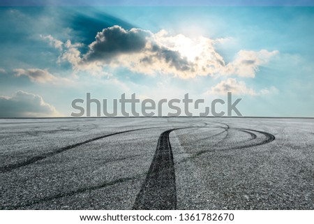 Asphalt race track ground and beautiful sky clouds at sunrise