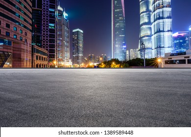 Асфальтовая гоночная трасса и современный горизонт и здания в Шанхае ночью