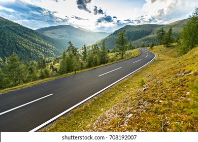 Asphalt road in Austria, Alps in a beautiful summer day, Nockalmstrasse.