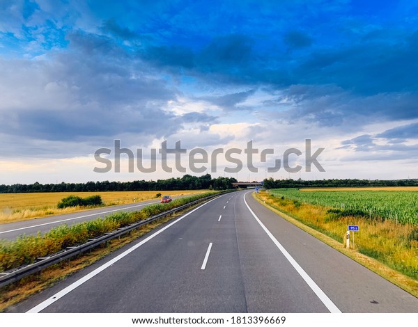 Asphalt\
road and beautiful nature landscape at\
sunset