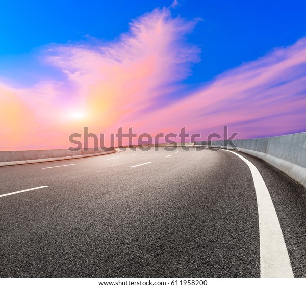 Asphalt road and\
beautiful sky at sunset