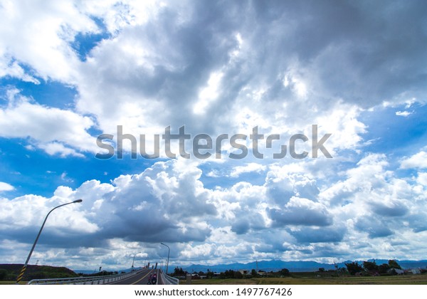  asphalt\
road and blue sky and white clouds\
scene