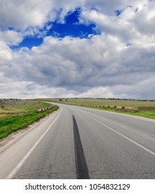 Asphalt Road With Brake Track And Low Clouds