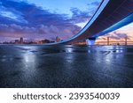 Asphalt road and bridge with city skyline at sunset in Macau