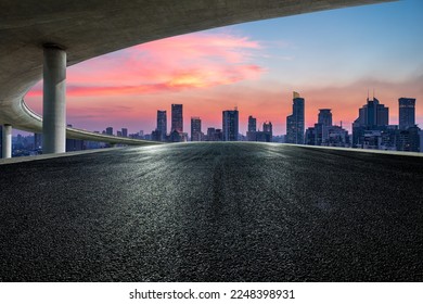 Asphalt road and bridge with city skyline at sunset in Shanghai, China. - Shutterstock ID 2248398931