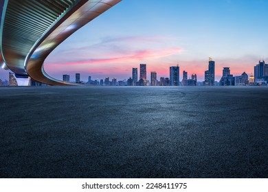 Asphalt road and bridge with city skyline in Shanghai at sunset, China.  - Shutterstock ID 2248411975