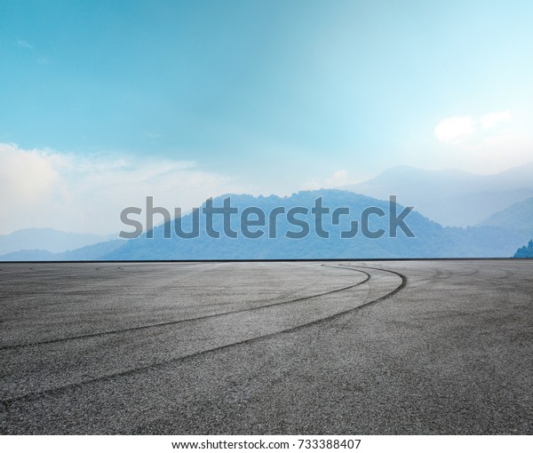 Asphalt road\
circuit and mountain under the blue\
sky