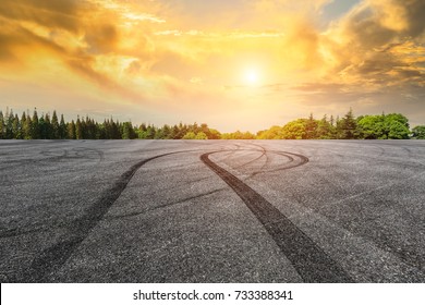 Asphalt Road Circuit And Sky Sunset With Car Tire Brake