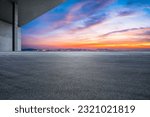 Asphalt road and city skyline with colorful sky clouds at sunset