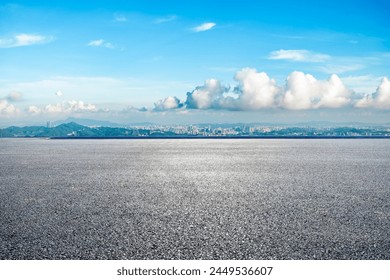 Asphalt road and city skyline with green mountain landscape on a sunny day. panoramic view. - Powered by Shutterstock