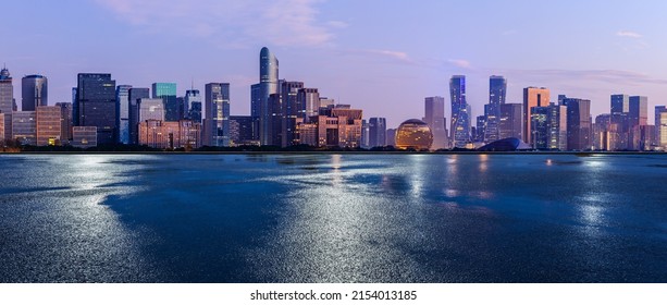 Asphalt road and city skyline with modern commercial buildings in Hangzhou at night, China. - Powered by Shutterstock