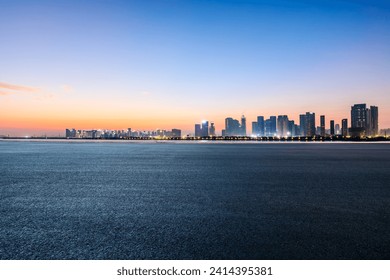 Asphalt road and city skyline with modern buildings at dawn - Powered by Shutterstock