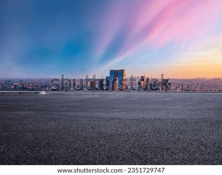 Asphalt road and city skyline with modern building at sunset in Suzhou, Jiangsu Province, China. High Angle view.