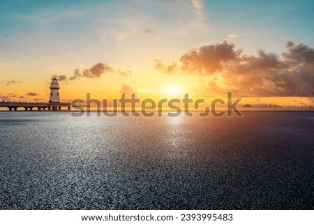 Asphalt road and coastline with lighthouse building in Zhuhai, Guangdong Province, China.