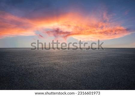 Asphalt road and colorful sky clouds at sunset