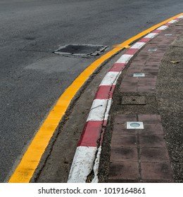Asphalt road and Concrete sidewalk with Red and white concrete curb