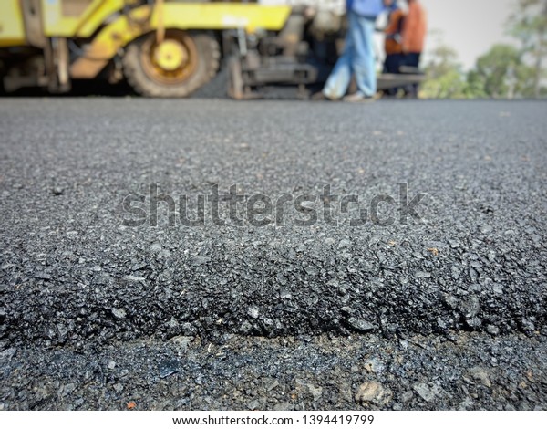 Asphalt\
road construction in Thailand, blurred\
images