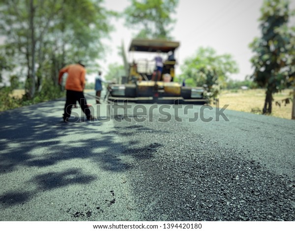 Asphalt\
road construction in Thailand, blurred\
images