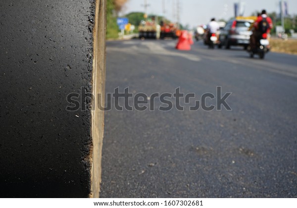 Asphalt\
road construction in Thailand, blurred\
pictures