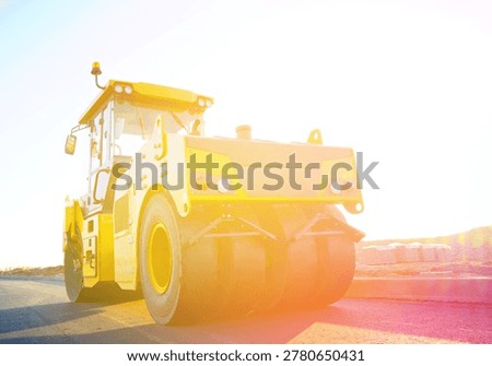 Asphalt road construction. Vibrator compactor machine on roadworks, asphalt pavement. Asphalt paving installation. Road roller on road construction. Vibration roller on highway asphalting. Road Construction Equipment