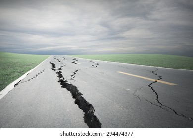 Asphalt Road Cracks And Collapsed With Storm Cloud