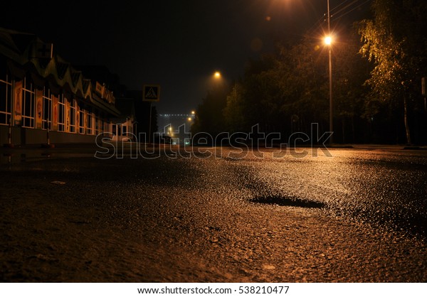 asphalt road in dark\
city