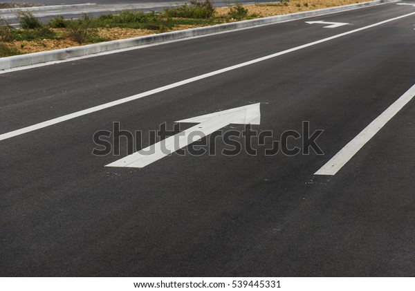 Asphalt road direction\
arrow