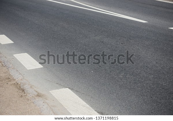 Asphalt road and dividing\
lines
