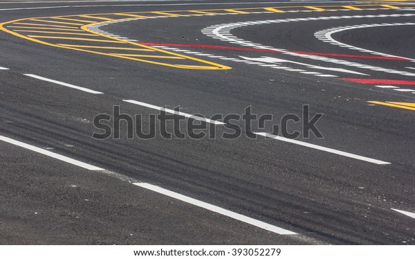 Asphalt road with dividing lines and tire tracks.\
Background photo\
texture