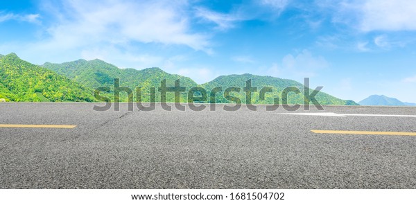 Asphalt road and green mountain nature landscape on\
sunny day,panoramic\
view.