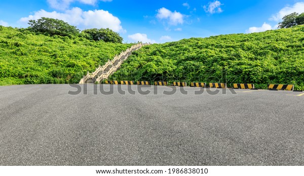 Asphalt road\
and green mountain nature\
landscape.