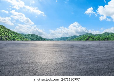 Asphalt road and green mountain with sky clouds natural background on sunny day
