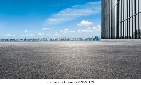 Asphalt road ground and city skyline with modern commercial building in Suzhou, China. 