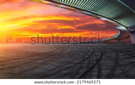 Asphalt road ground and city skyline with bridge architecture at sunset in Suzhou, China. 