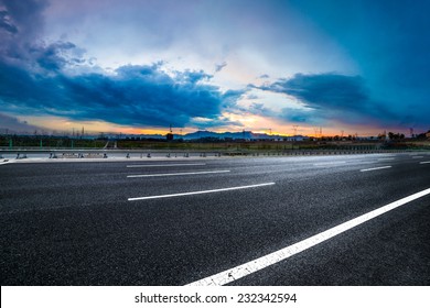 Asphalt road High way Empty curved road clouds and sky at sunset - Shutterstock ID 232342594