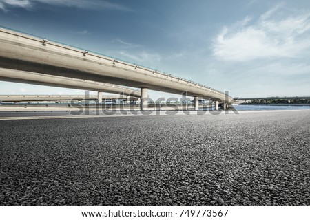 Asphalt road and highway bridge under the blue sky
