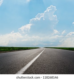 Asphalt Road To Horizon In Cloudy Sky