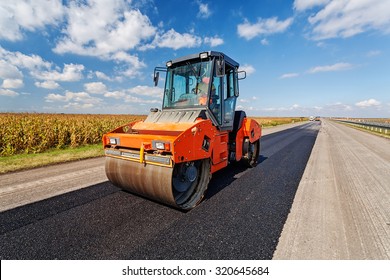 Asphalt Road Making Construction Site With Heavy Machines