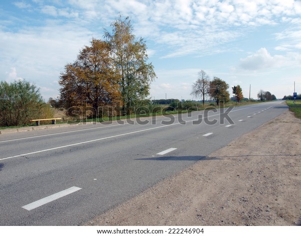 Asphalt\
road with marker lines in rural district      \
